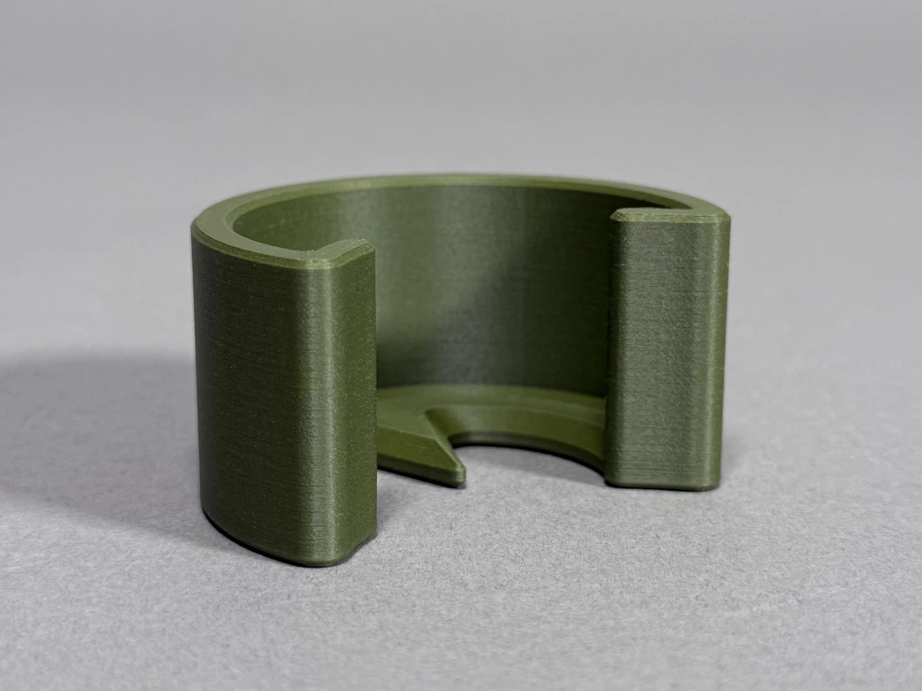 Green 3D-printed ball marker on a gray background