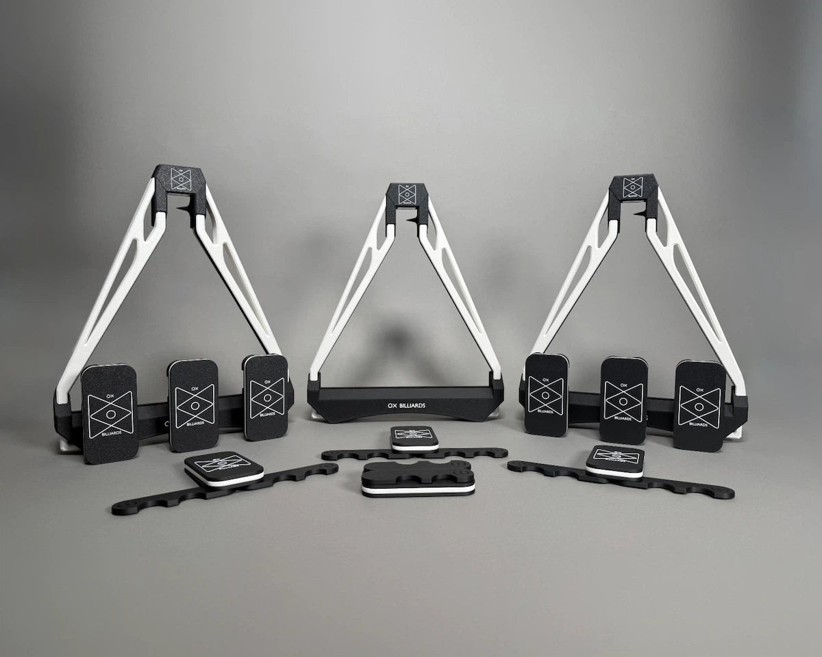 Three white and black triangles on a gray studio background.