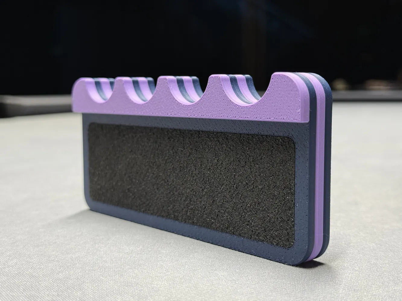 The rubber bottom of the club cue holder