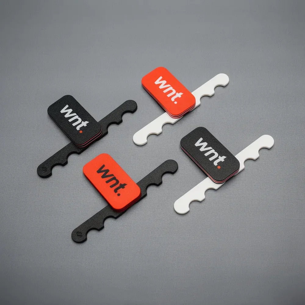 Set of four cue stand  with 'wnt.' branding on a gray background