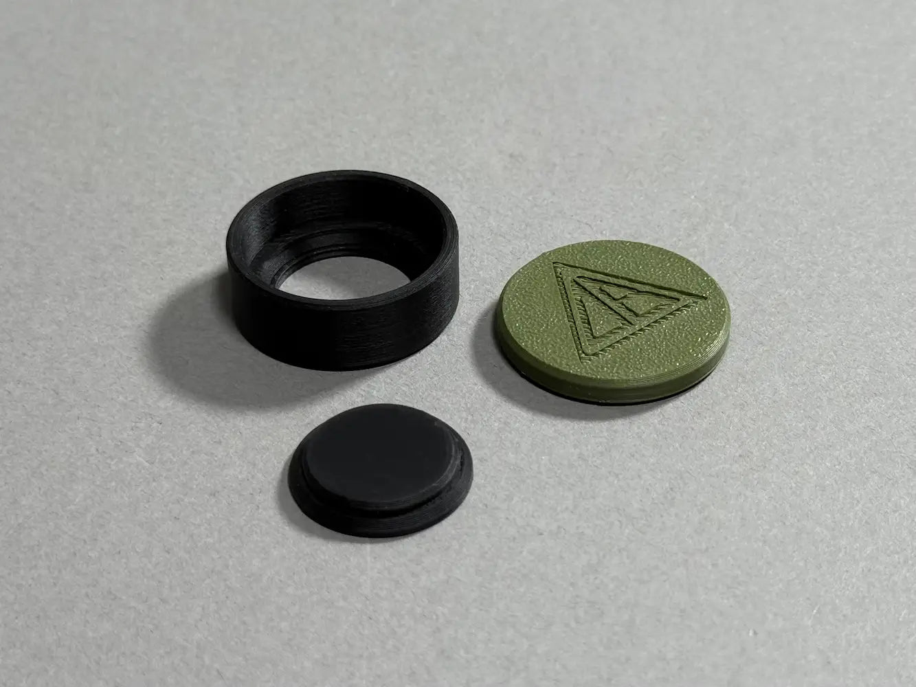 three parts of a magnetic chalk holder 